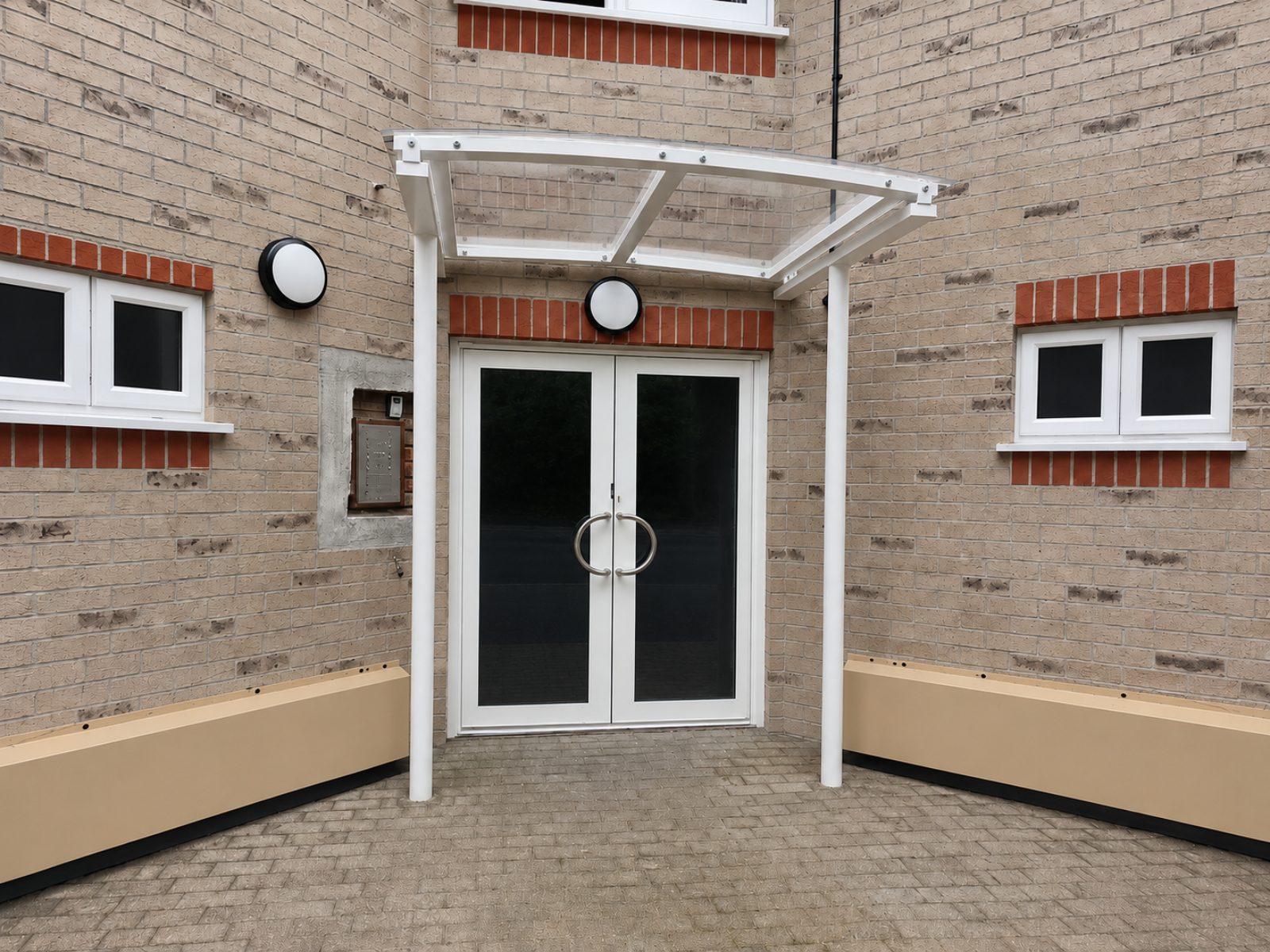 White commercial entrance canopy installed by Canopies & Shelters Ltd