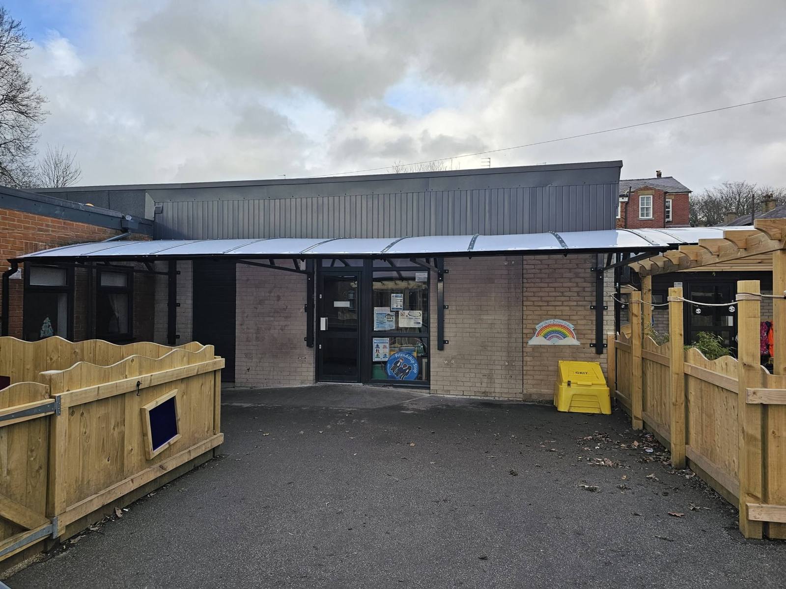 Front view of the dark curved canopy running along the entrance wall at St Luke's CE Primary School, Heywood