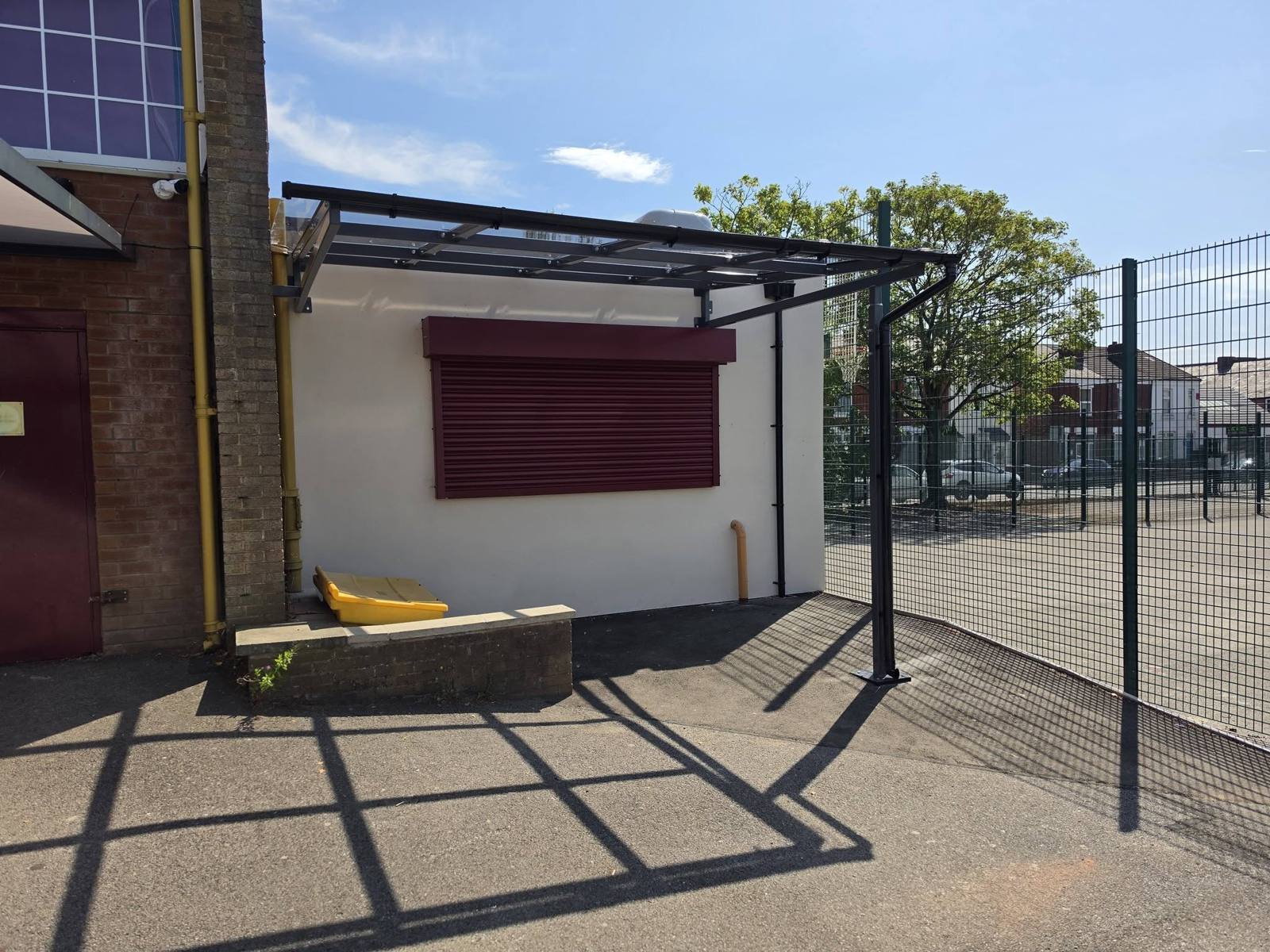 Steel canopy over the outdoor servery and eating area at Stockport School