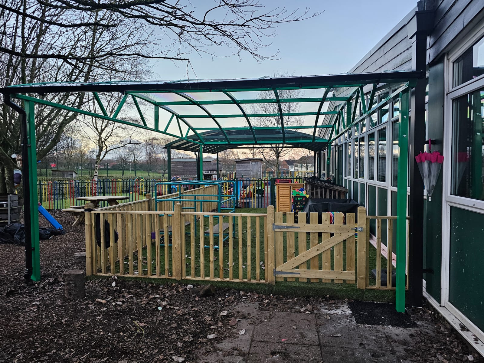Green school playground canopy installed by Canopies & Shelters Ltd